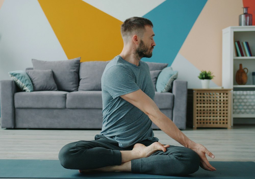 Man stretching at home